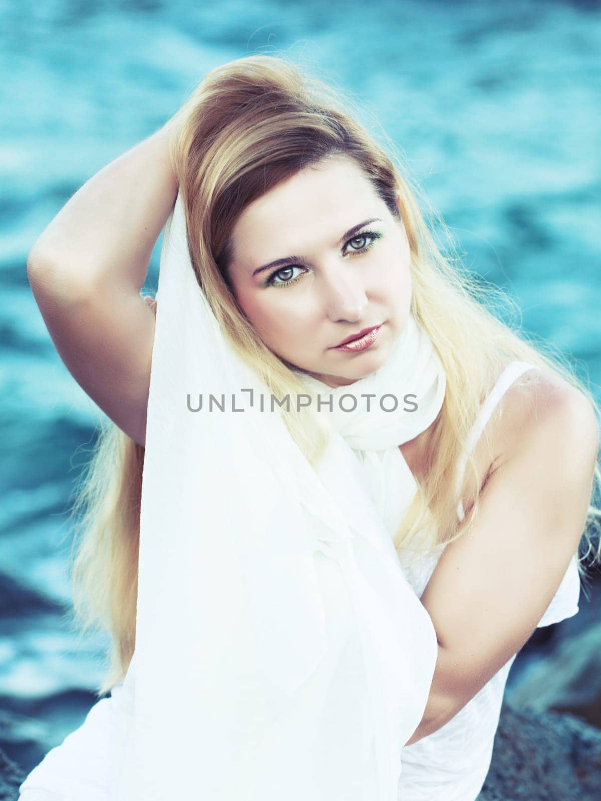 Young beautiful woman posing near the ocean