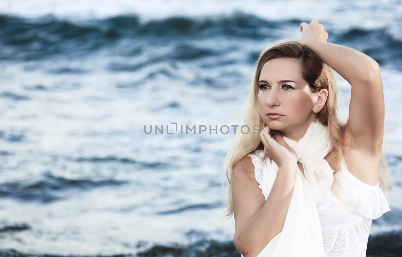 Young beautiful woman posing near the ocean