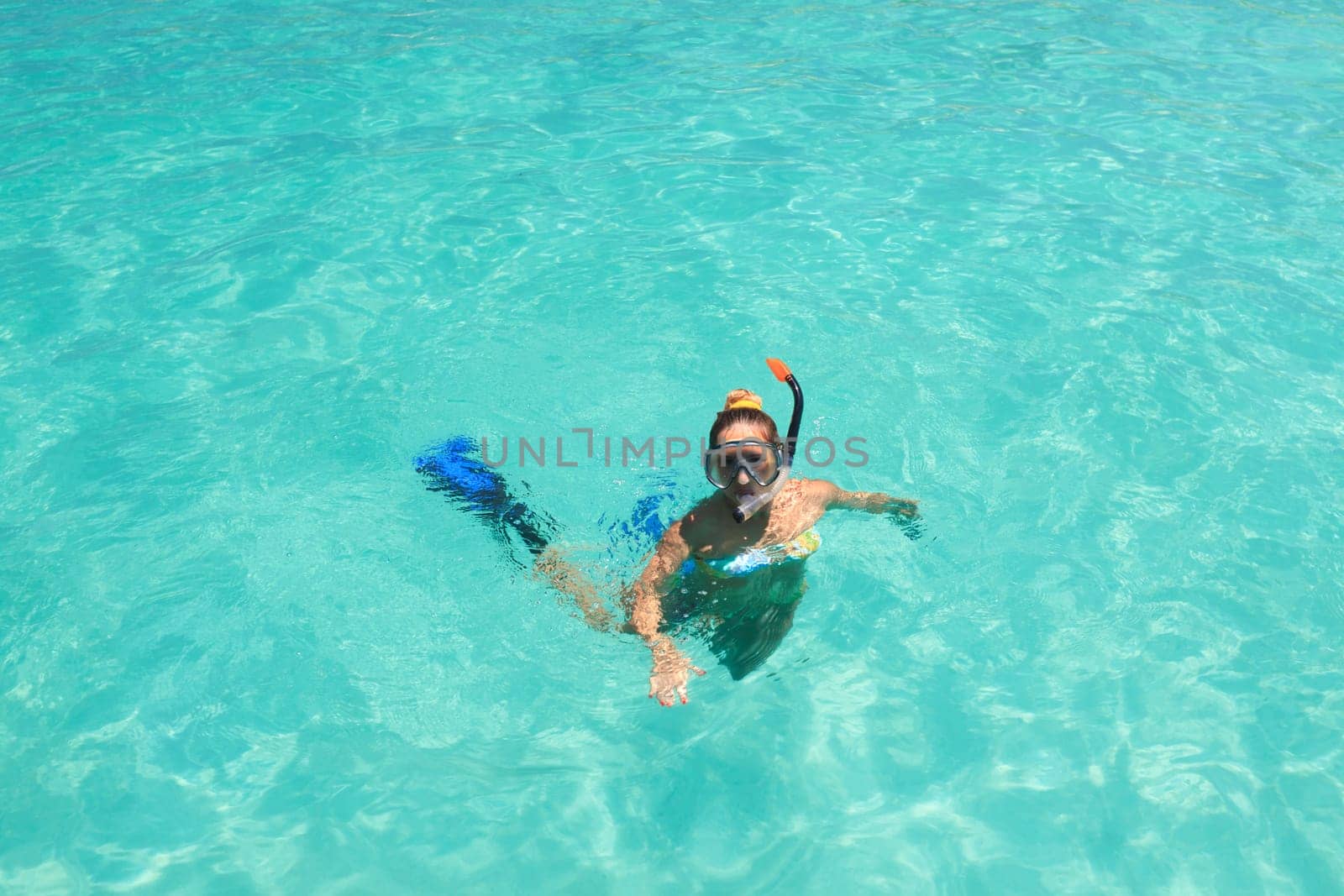 Young woman snorkeling in a tropical lagoon