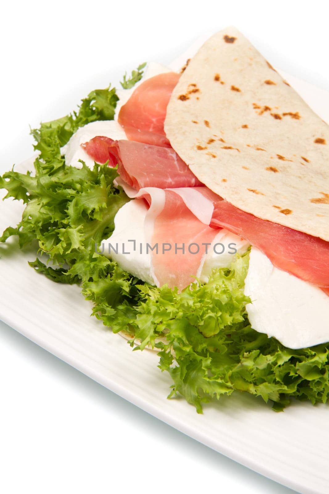 italian piadina with ham, fresh salad and mozzarella cheese