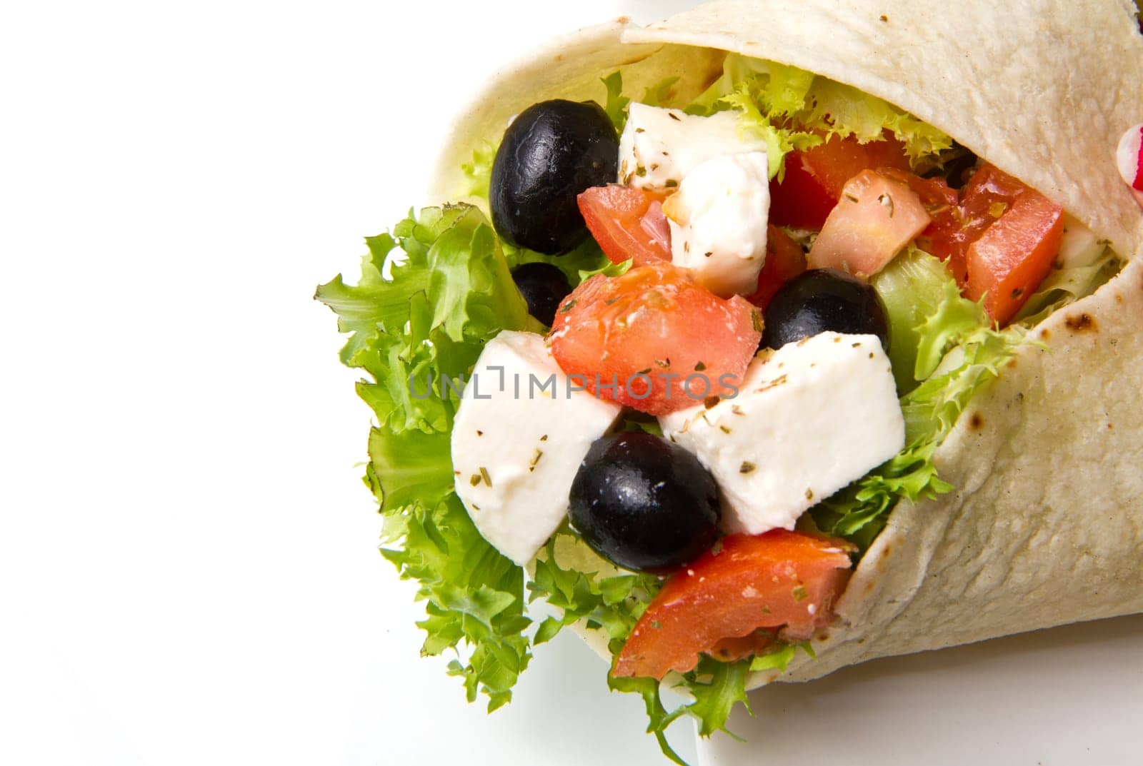 vegetarian piadina with fresh salad, tomatoes, olives and mozzarella cheese