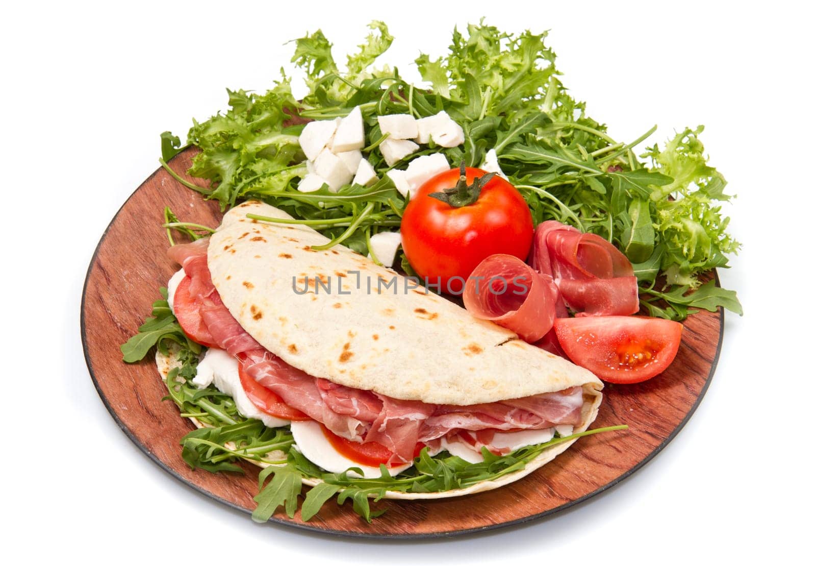 italian piadina with ham, fresh salad and mozzarella cheese