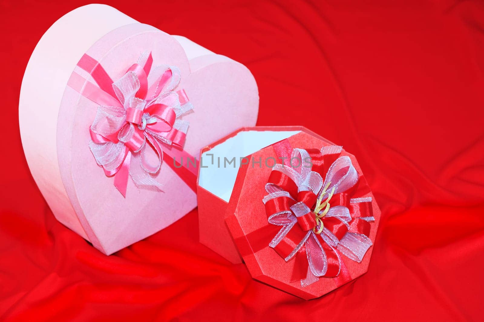 Gift box on the red silk background