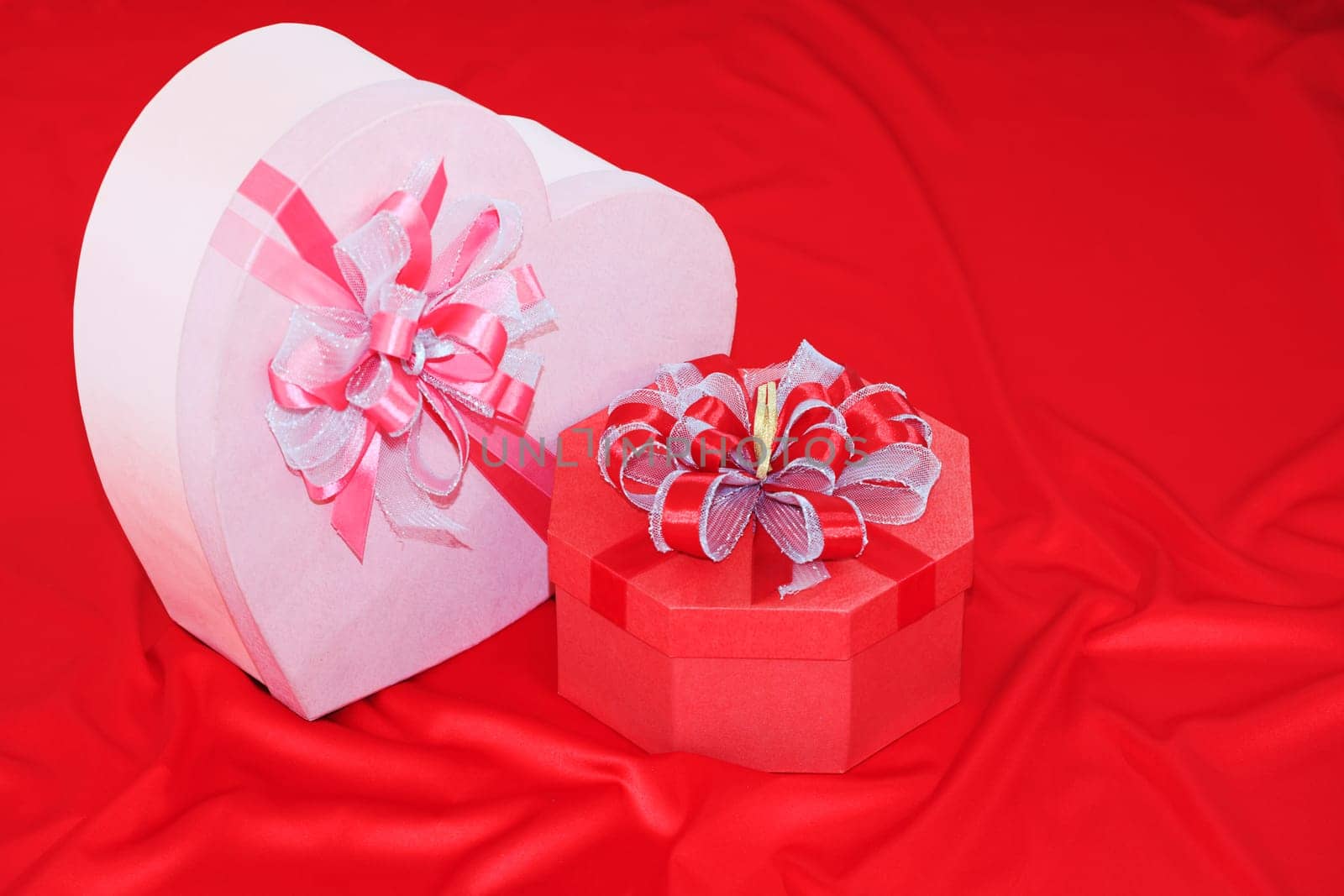 Gift box on the red silk background