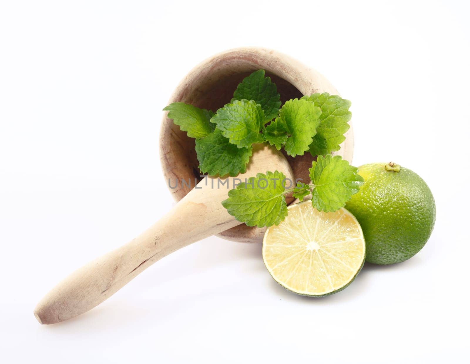 Mint and Lime in a mortar with pestle isolated on white background, for my Drink and Cocktail concepts