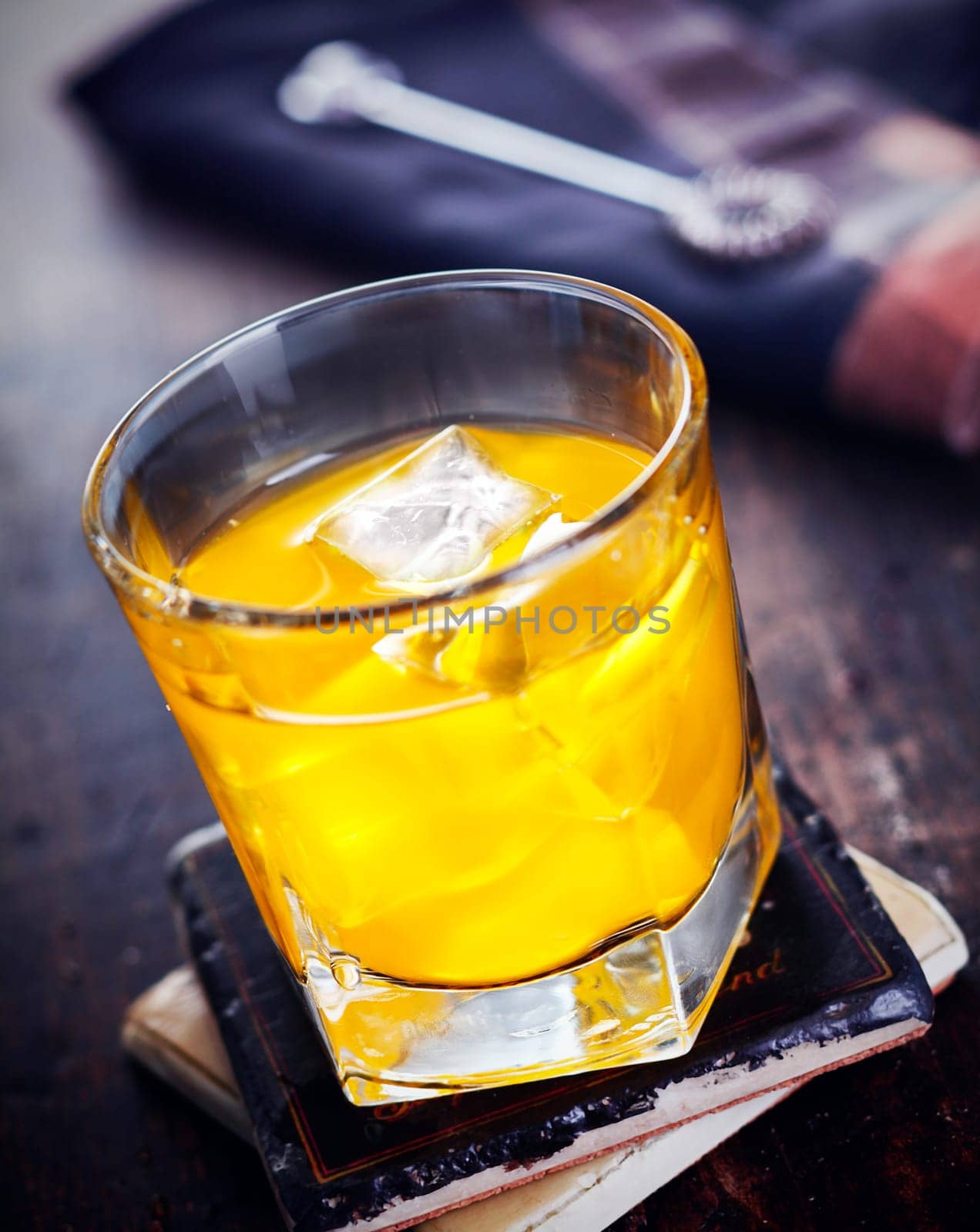 Hard Liquor with Orange juice standing on a coaster, on a wooden, vintage background, for Drink and Cocktail concepts
