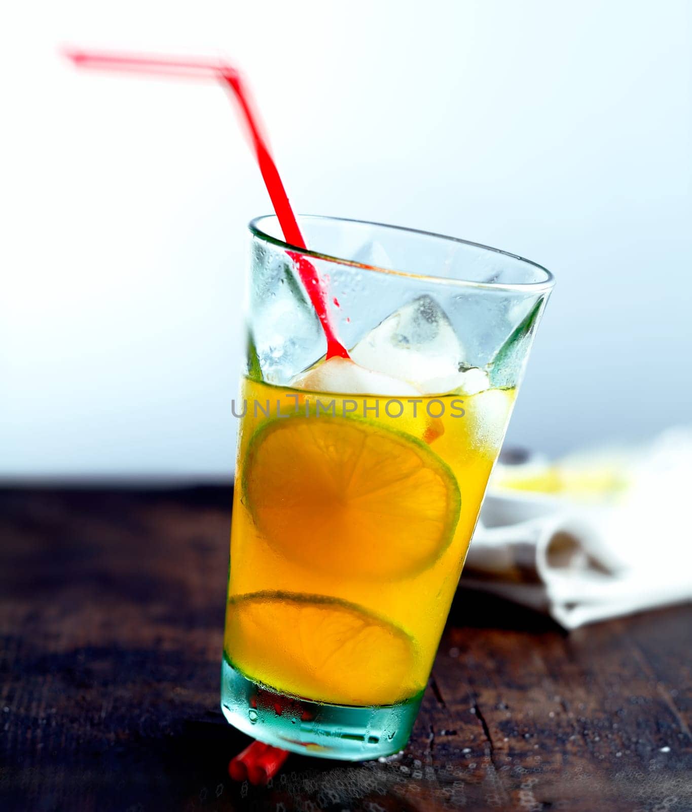 Juicy Drink with a straw on a wooden, ancient plate