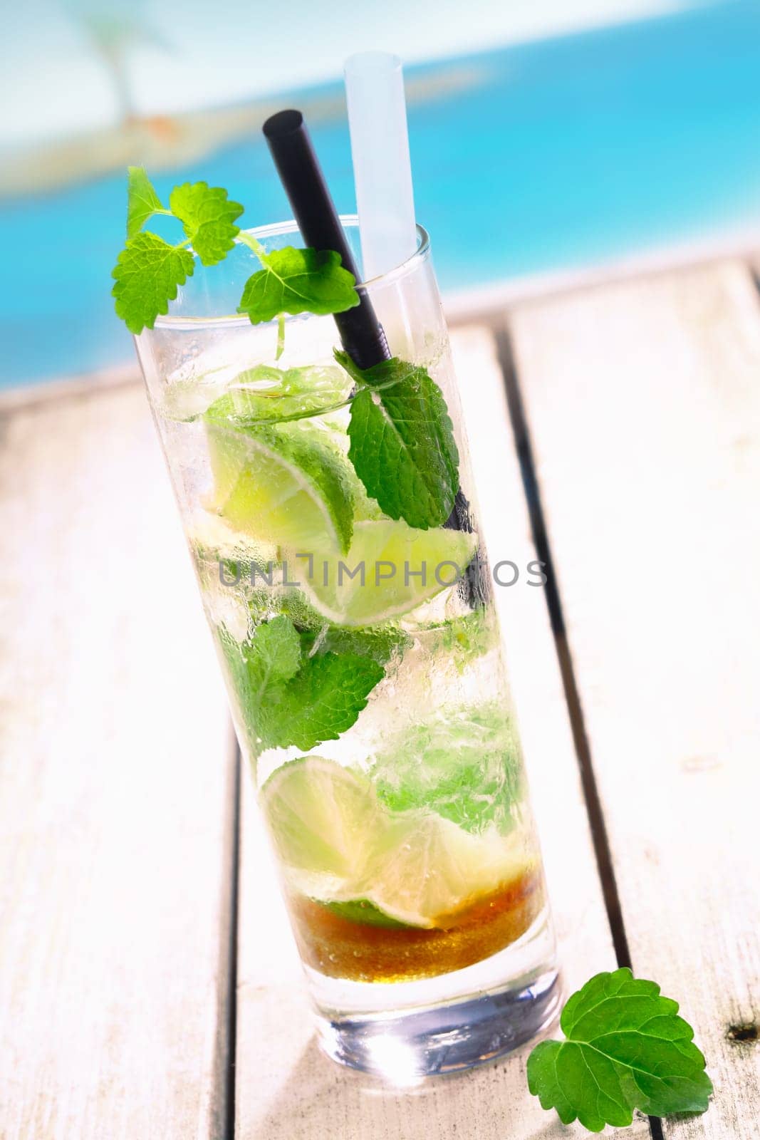 Mojito Drink standing on a bridge near the pacific sea. For tropical Cocktail concepts. More beverages in my portofolio.