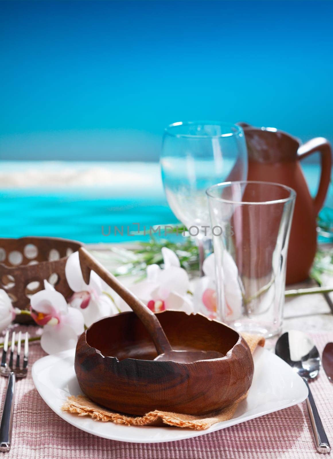 Ethnic table setting with handcrafted pottery blended into modern design at a tropical vacation resort