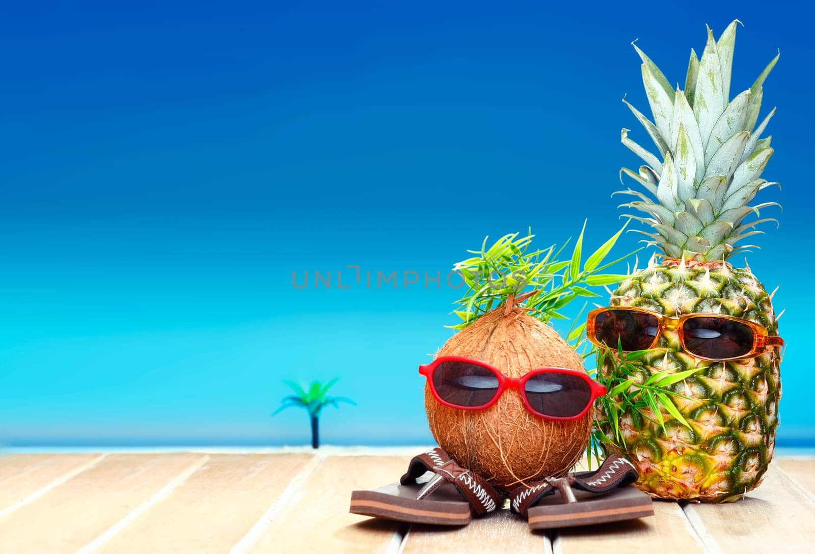 Two fruity friends, a coconut and pineapple, with fun foliage haistyles and trendy sunglasses in tropical paradise