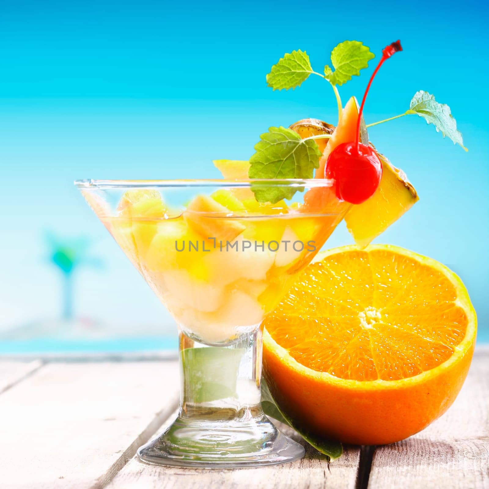 Fruit Salad with fresh Fruits on a deck near the beach