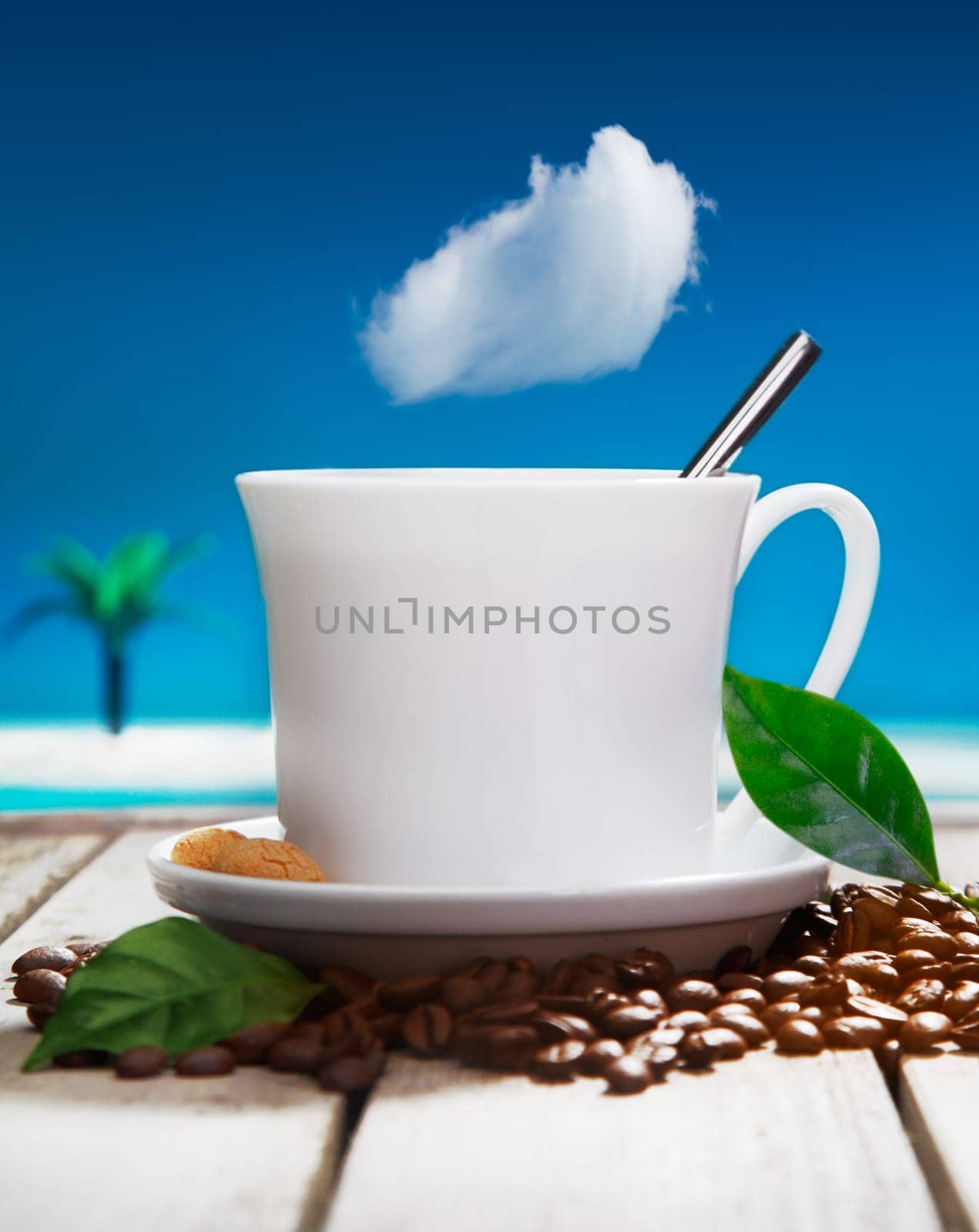 Freshly brewed cup of aromatic coffee with fresh coffee beans on a wooden deck overlooking the ocean at a tropical resort
