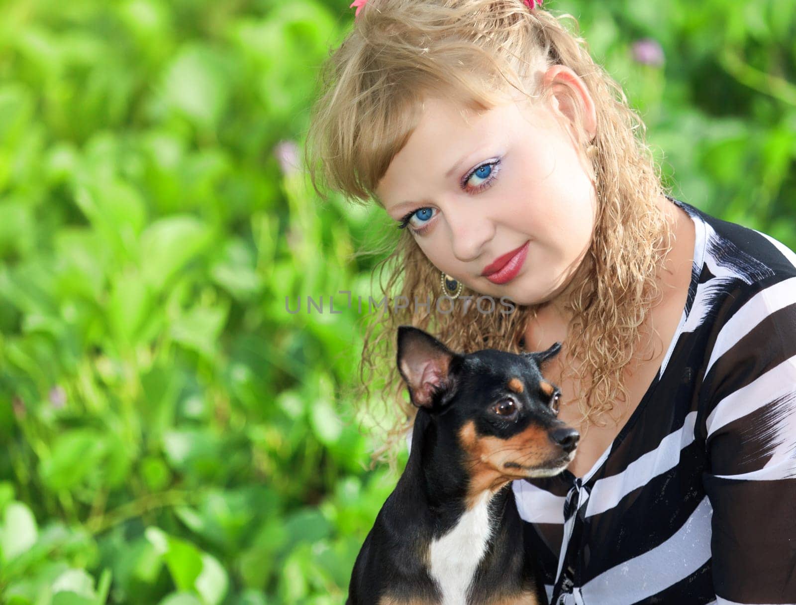 Beautiful young woman with her pet dog outdoor
