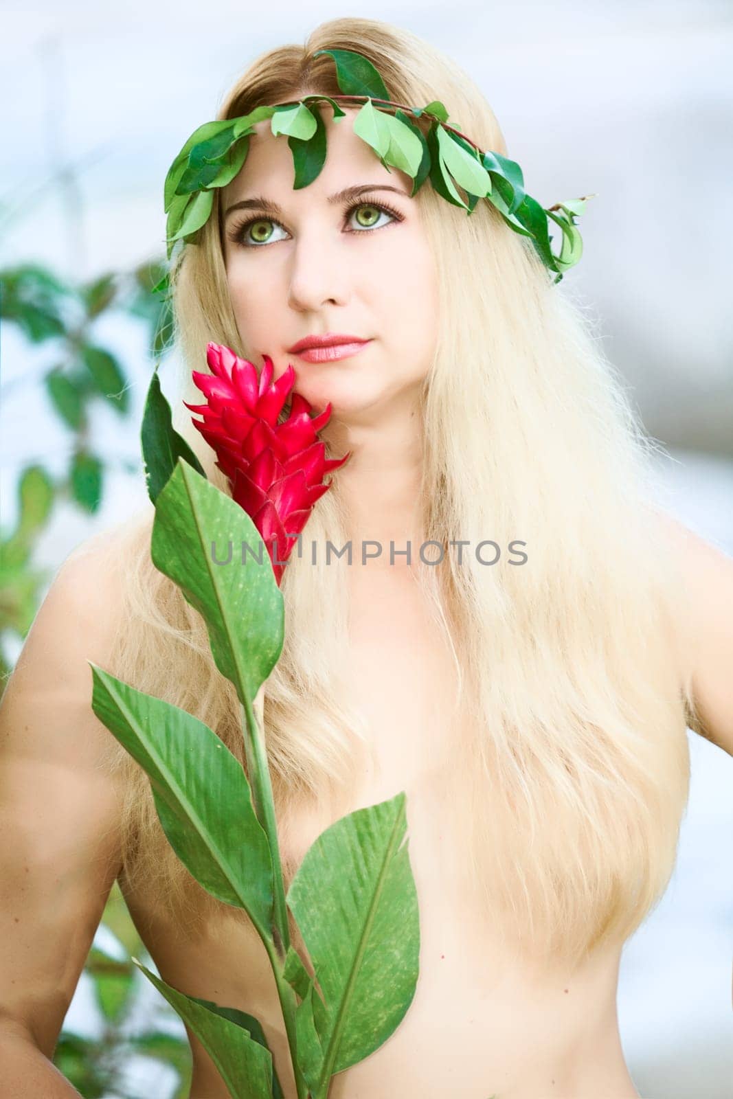 Beautiful woman as a forest nymph on the river