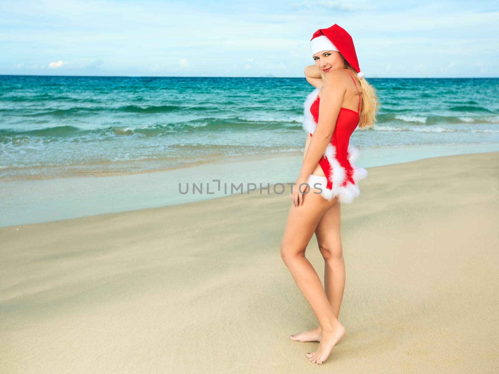 Beauriful sexy Santa at the tropical beach