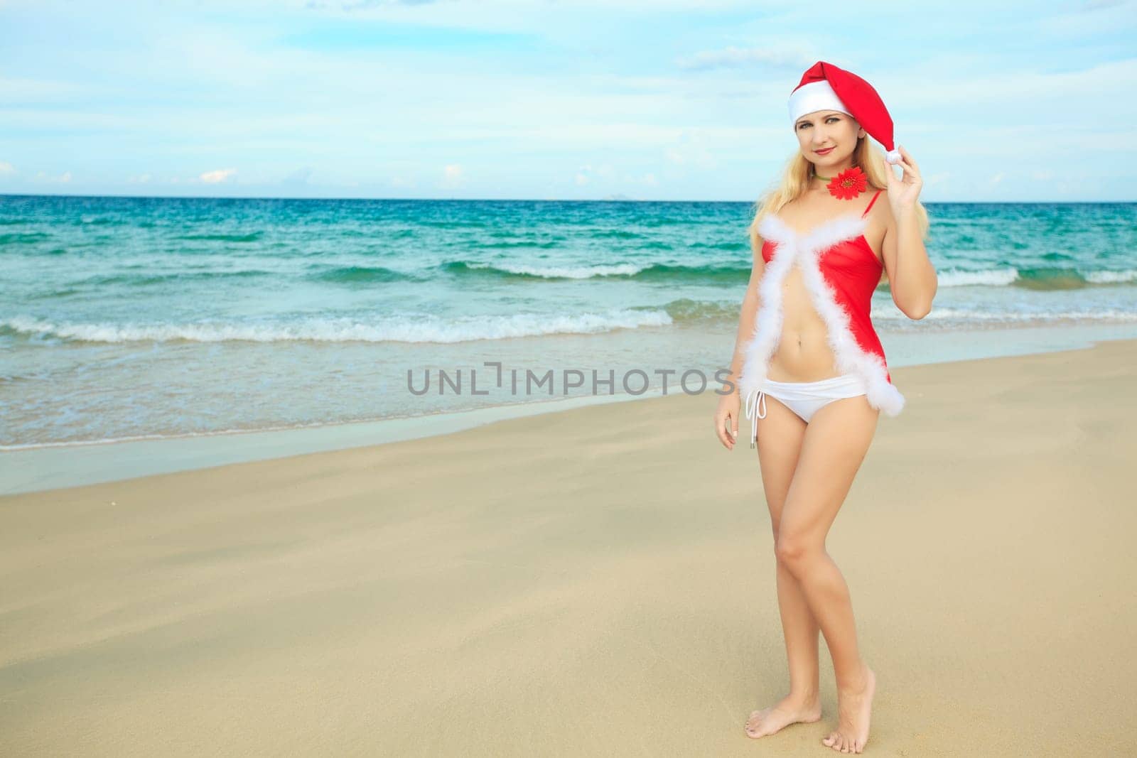 Beauriful sexy Santa at the tropical beach