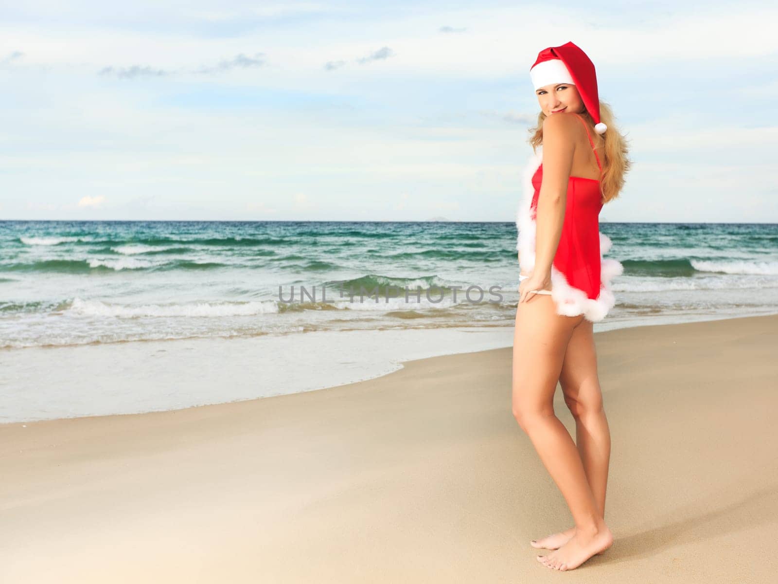 Beauriful sexy Santa at the tropical beach