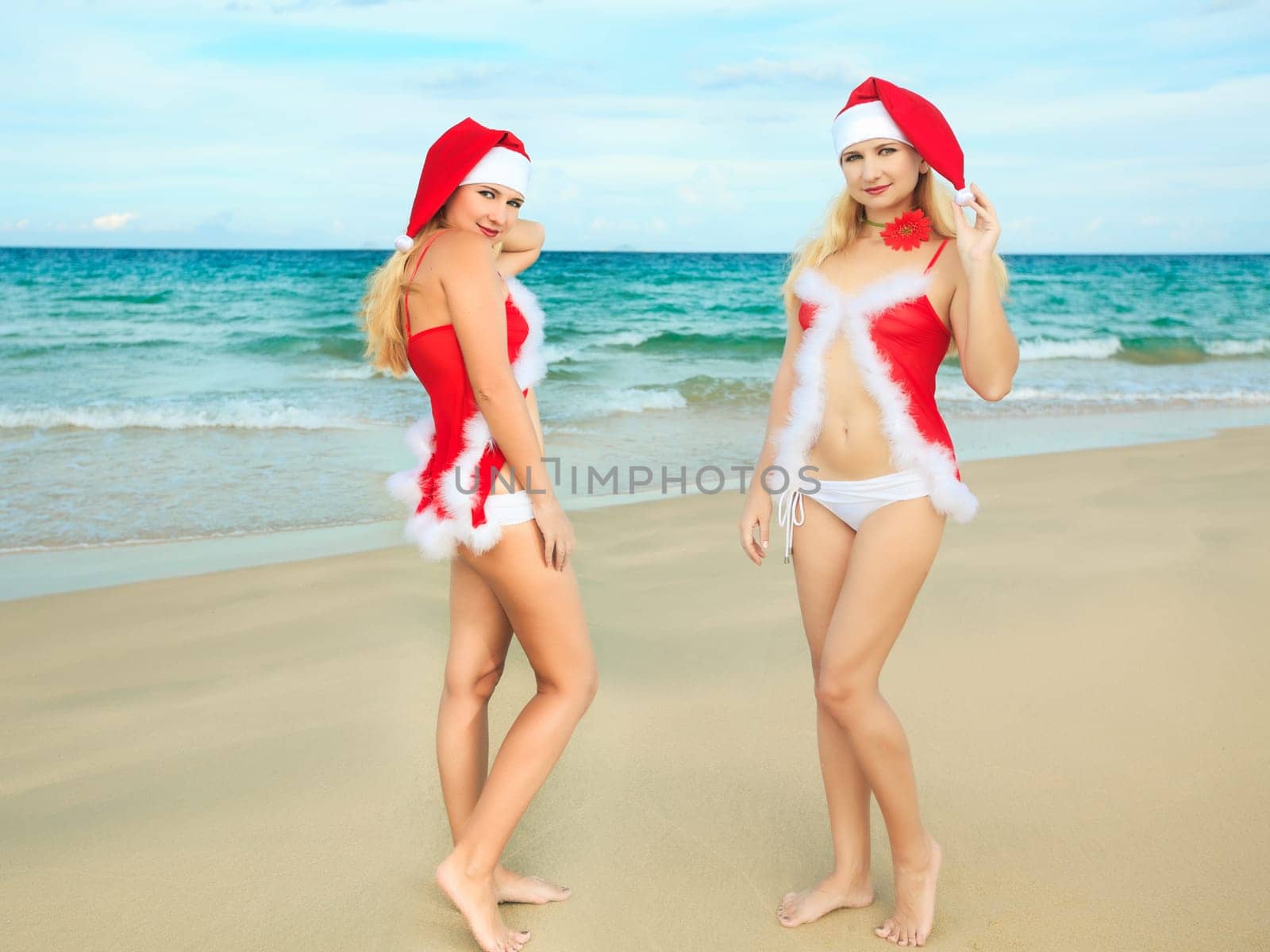 Two beauriful  Santa at the tropical beach