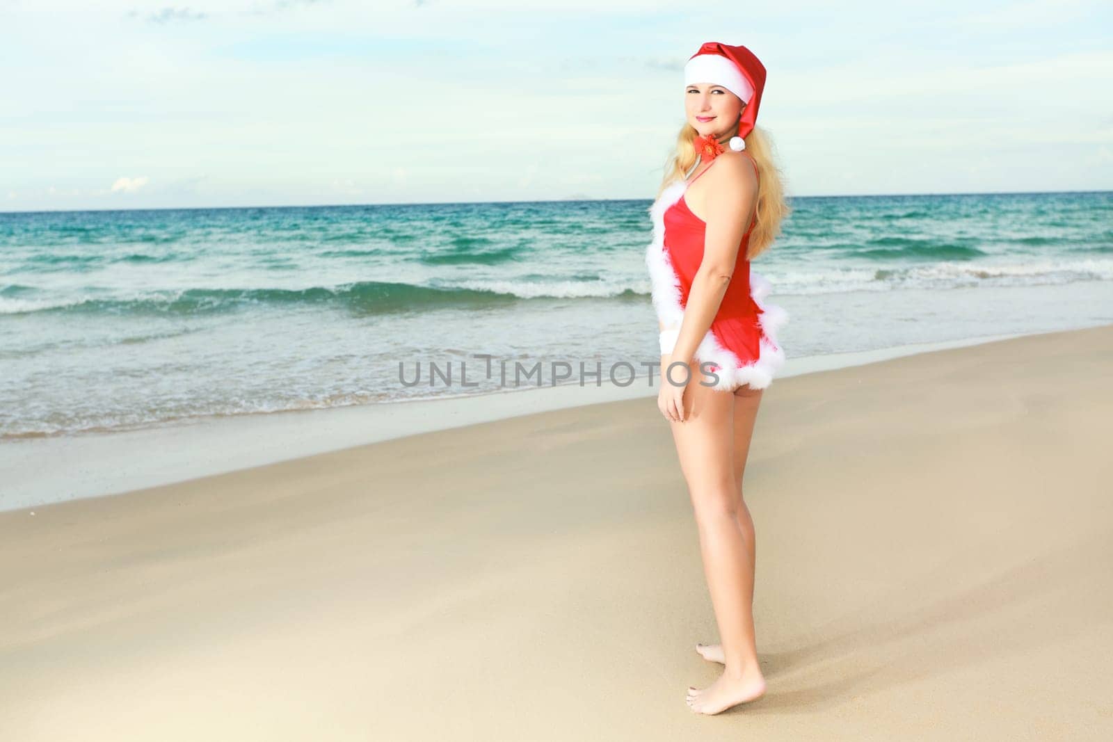Beauriful sexy Santa at the tropical beach