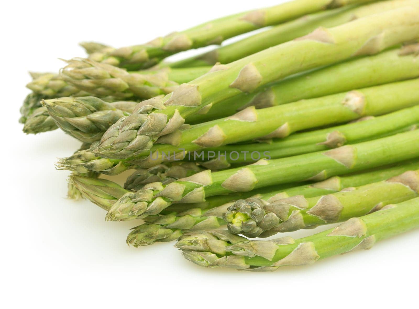 Spears of Fresh Uncooked Asparagus on White Background - Shallow Depth of Field