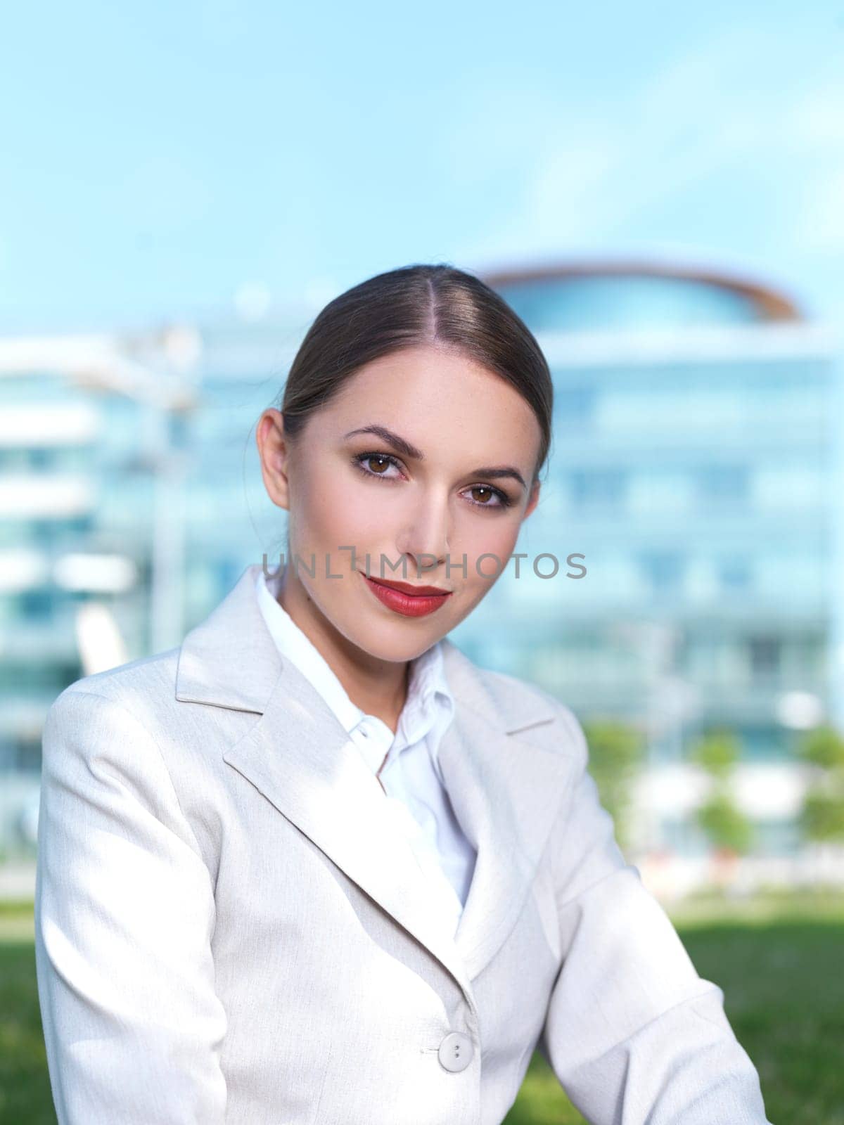 Beautiful Business woman sitting on grass