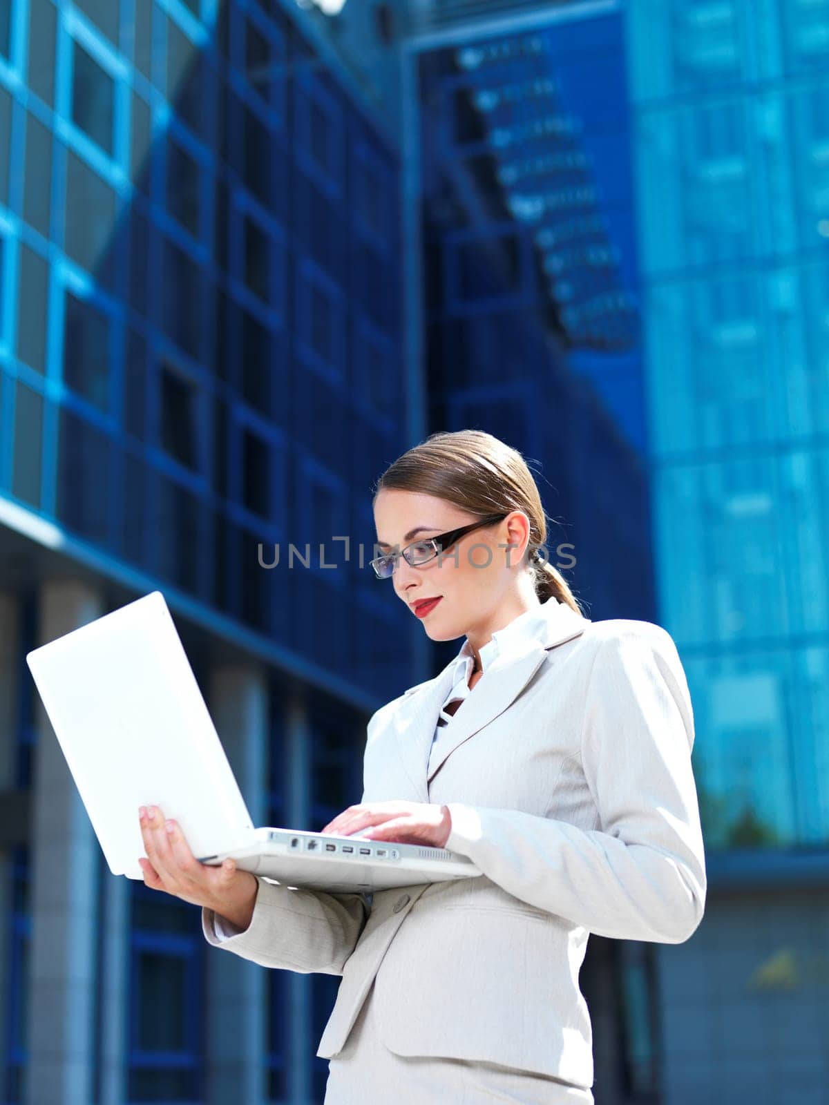 Beautiful business woman standing outdoor modern building