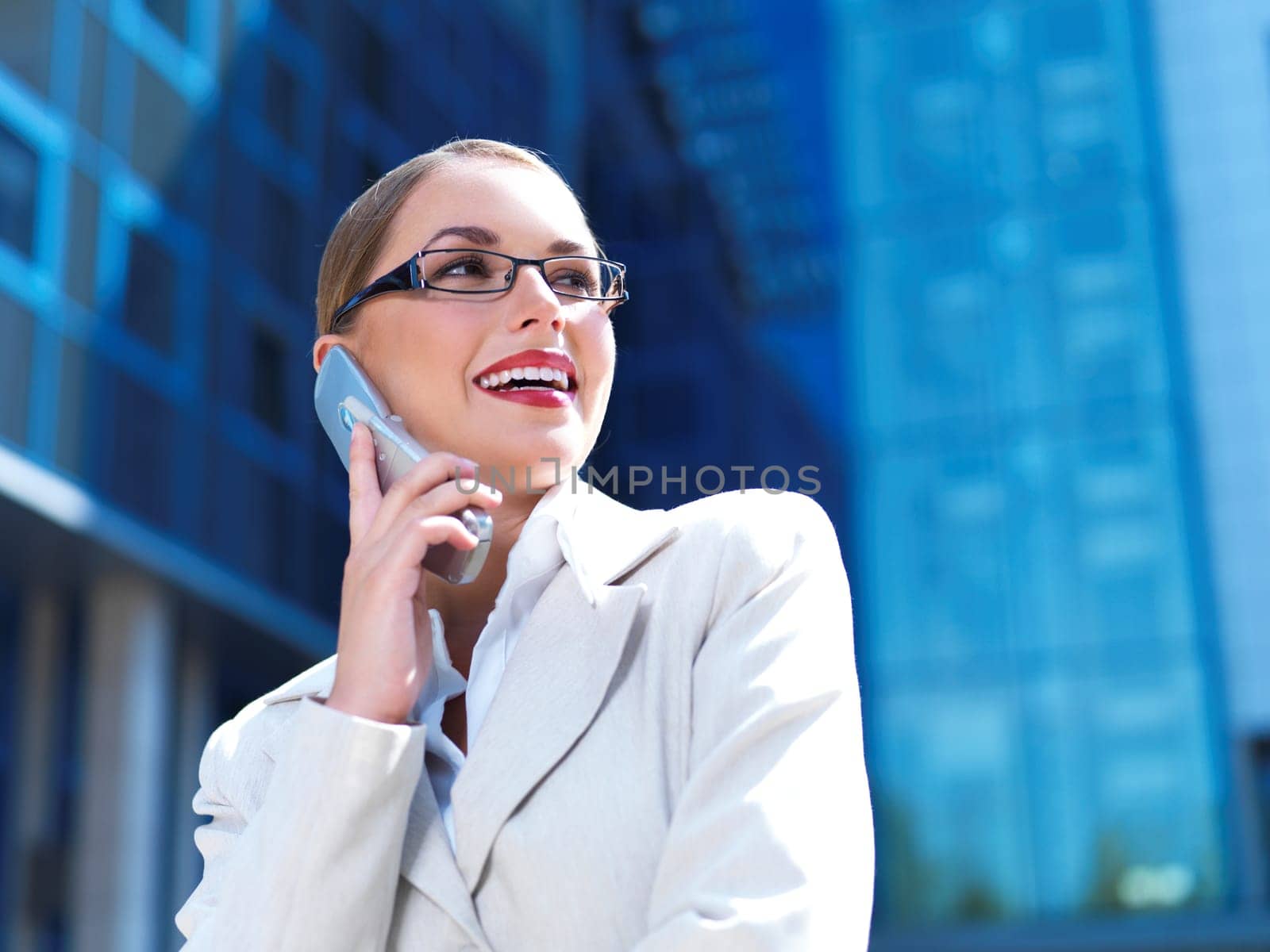 Beautiful business woman on the phone at modern building