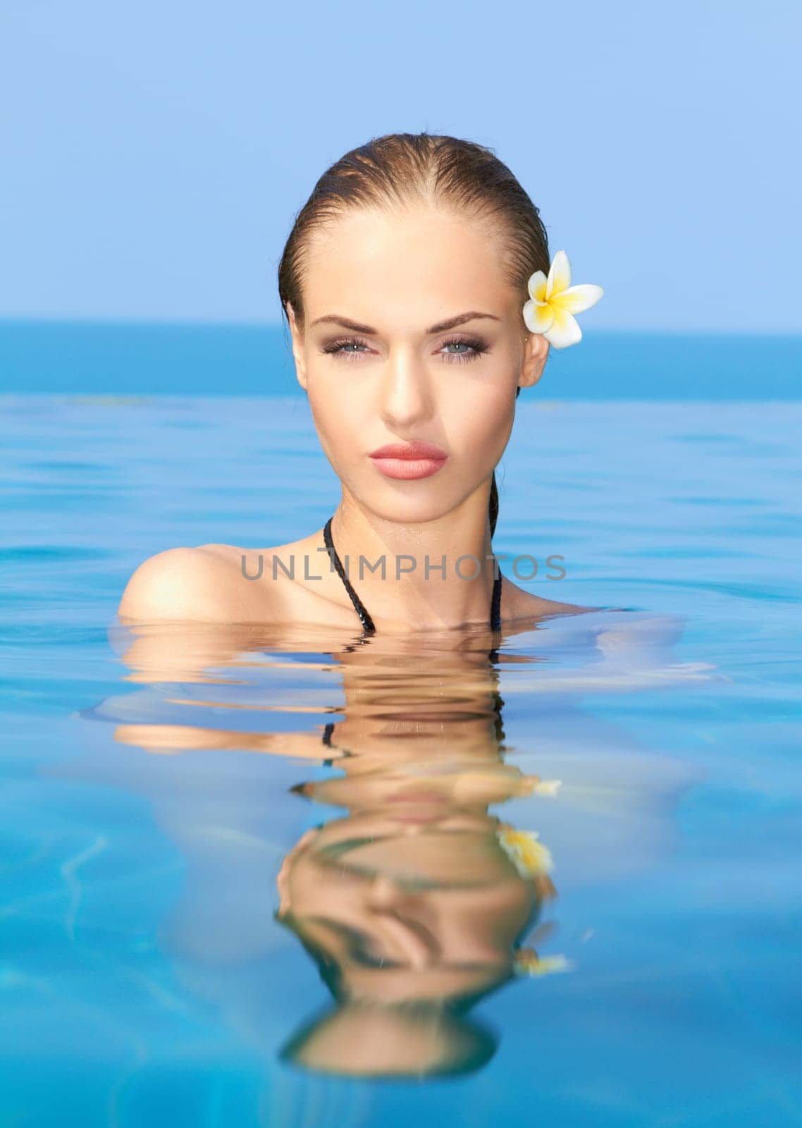 Cute blond girl relaxing in swimming pool
