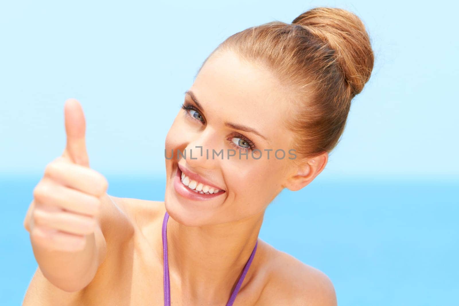 Portrait of happy woman with thumb up gesture