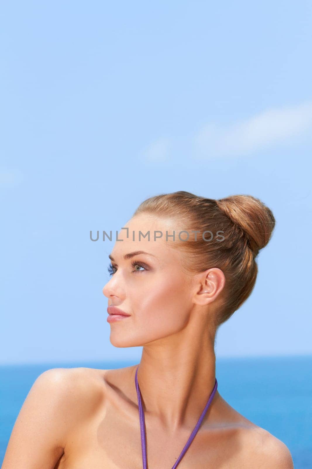 Portrait of gorgeous young woman smiling while looking at her right