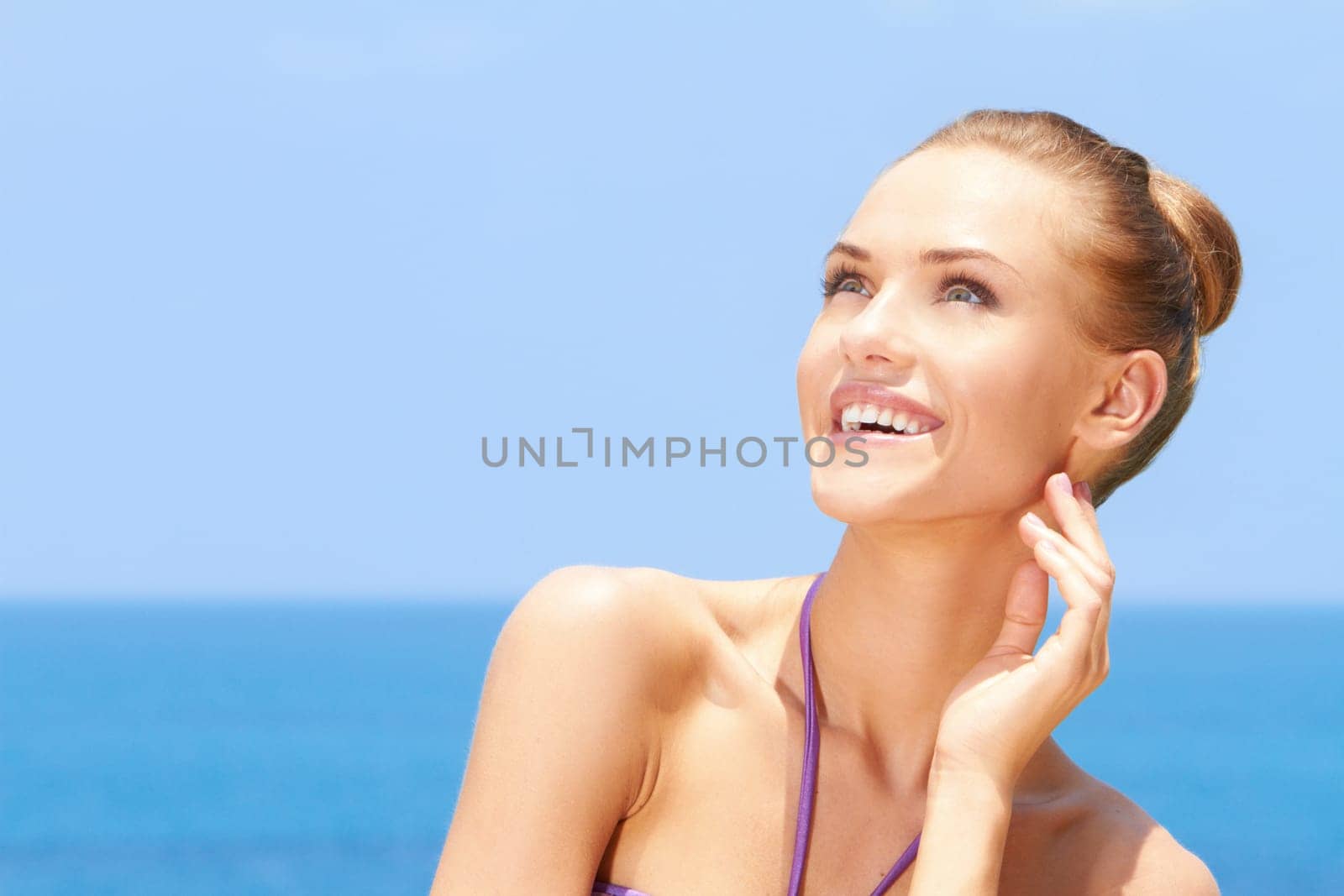 Portrait of gorgeous young woman smiling while looking at her right