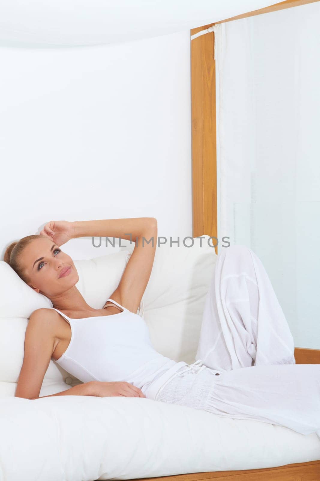 Woman relaxing on a canopied seat enjoying luxury