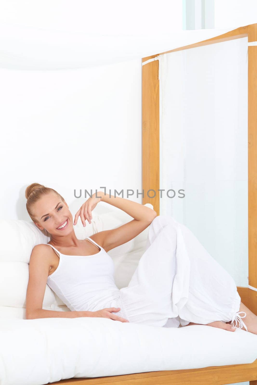 Woman relaxing on a canopied seat enjoying luxury