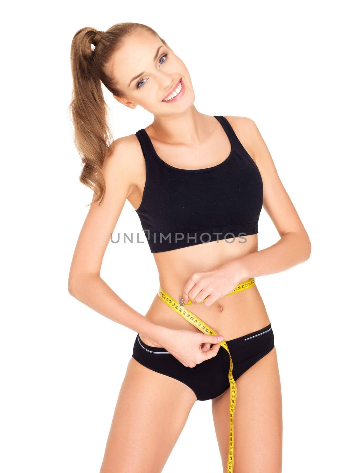 Fitness woman in black sports clothes isolated on white