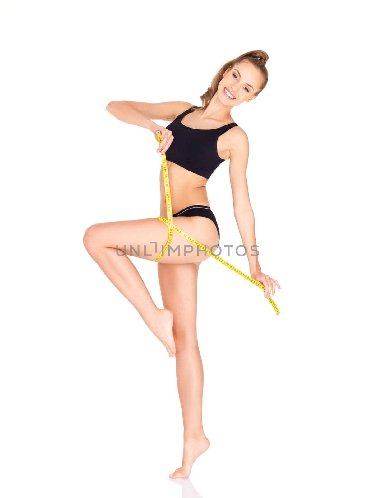 Fitness woman in black sports clothes isolated on white