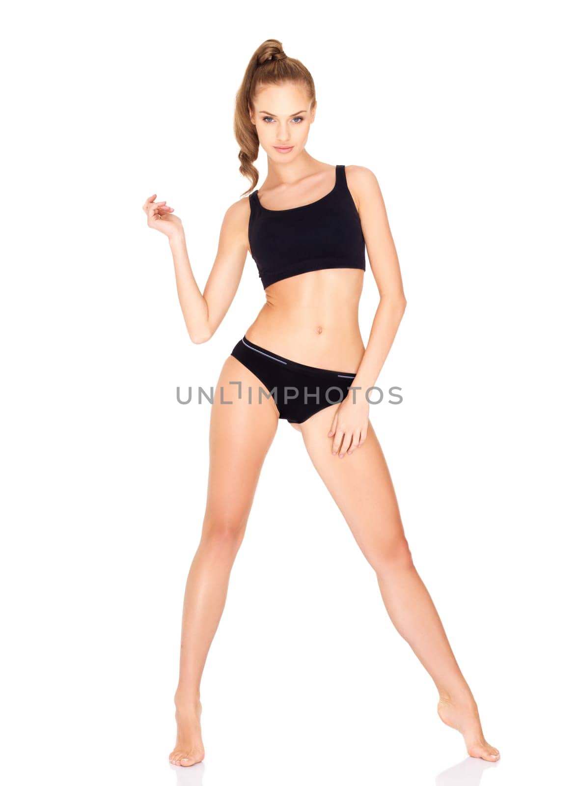 Fitness woman in black sports clothes isolated on white
