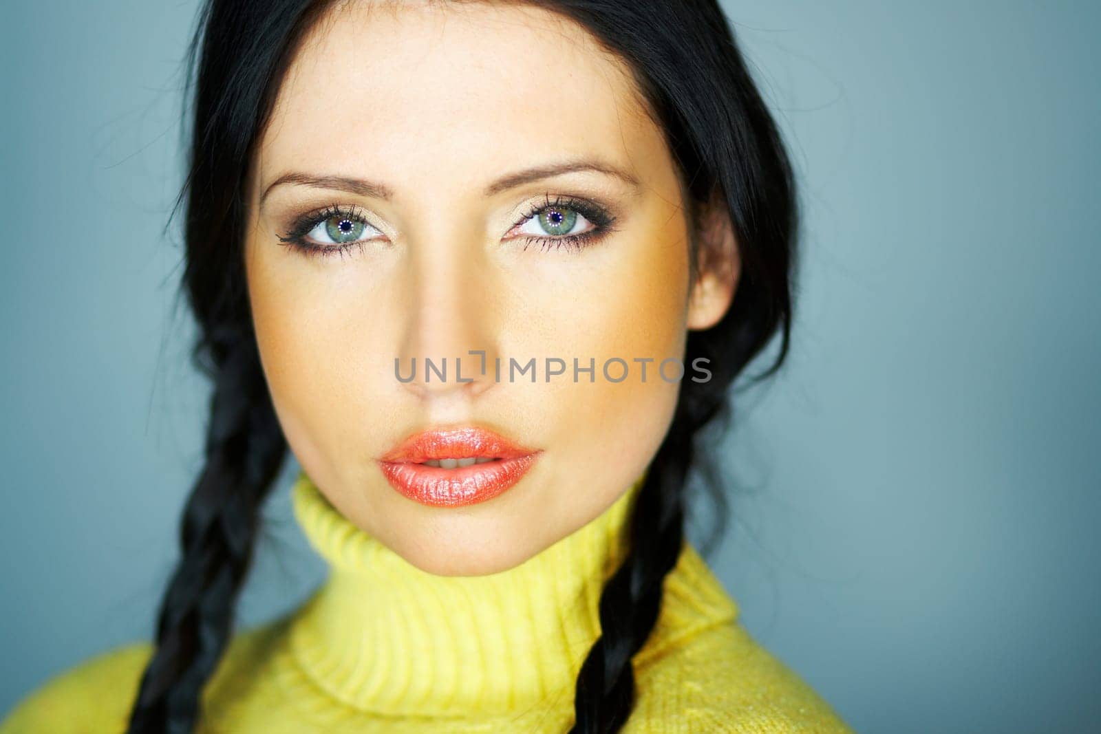 Portrait of beautiful woman wearing yellow sweater