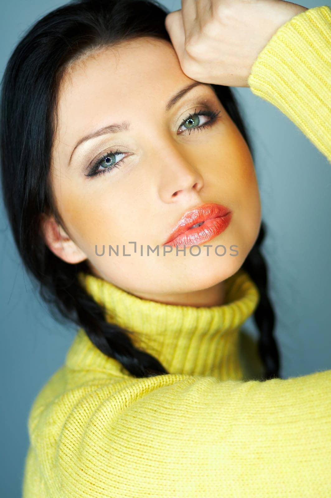 Portrait of beautiful woman wearing yellow sweater