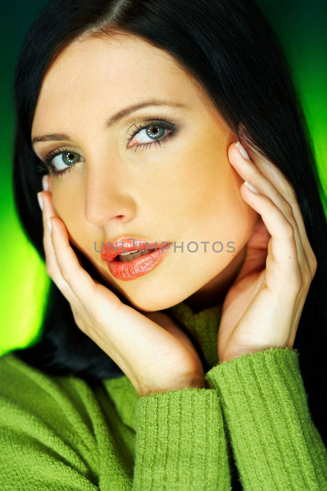 Portrait of beautiful woman wearing green sweater