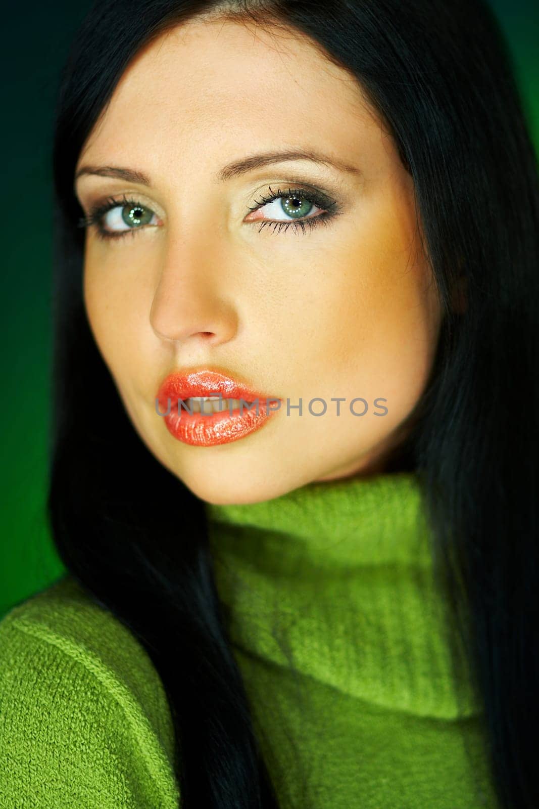 Portrait of beautiful woman wearing green sweater