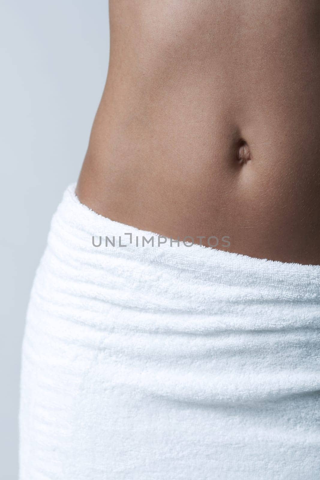 Beautiful womans body part wearing white towel on clear background