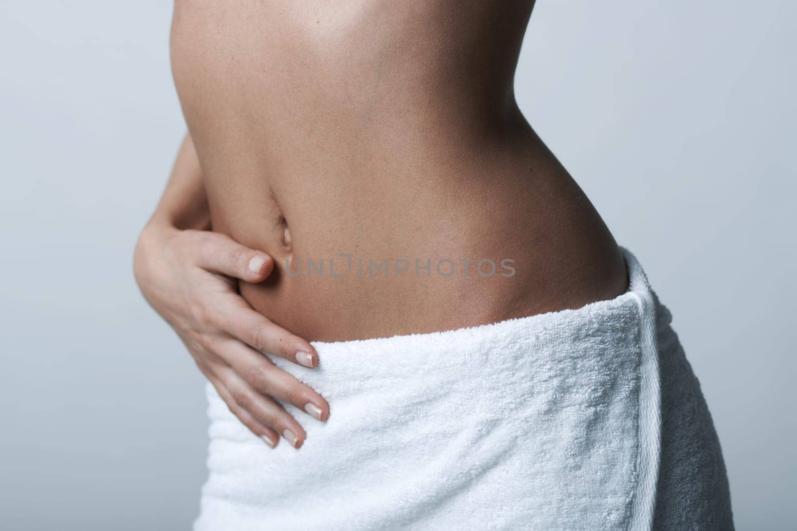 Beautiful womans body part wearing white towel on clear background