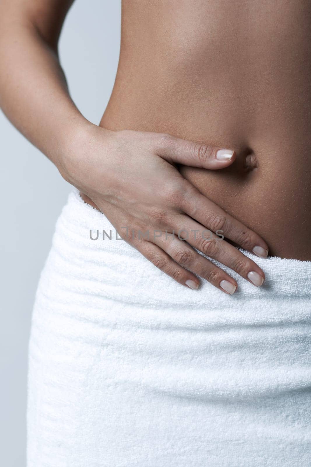 Beautiful womans body part wearing white towel on clear background