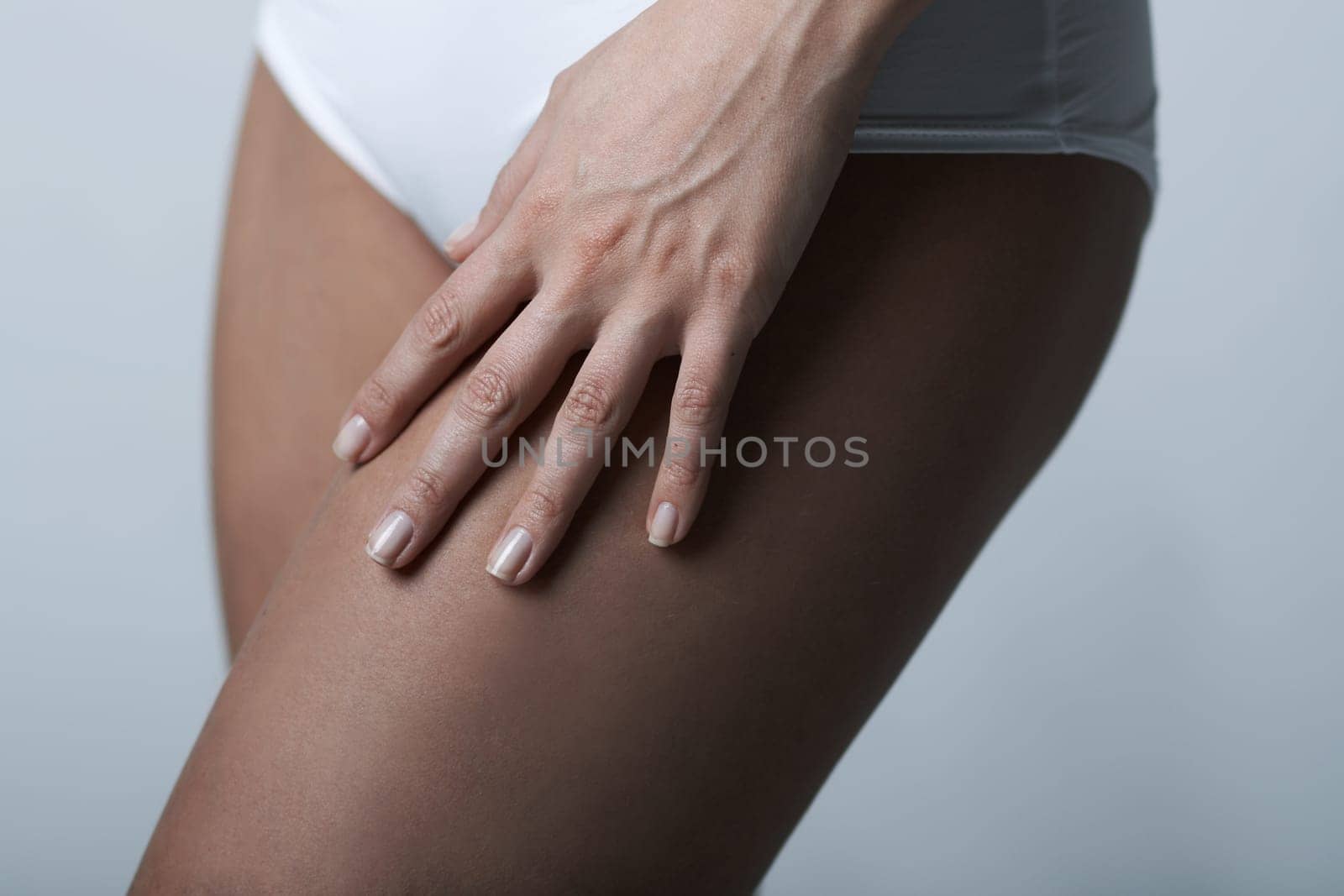 Beautiful womans body part wearing white underwear on clear background