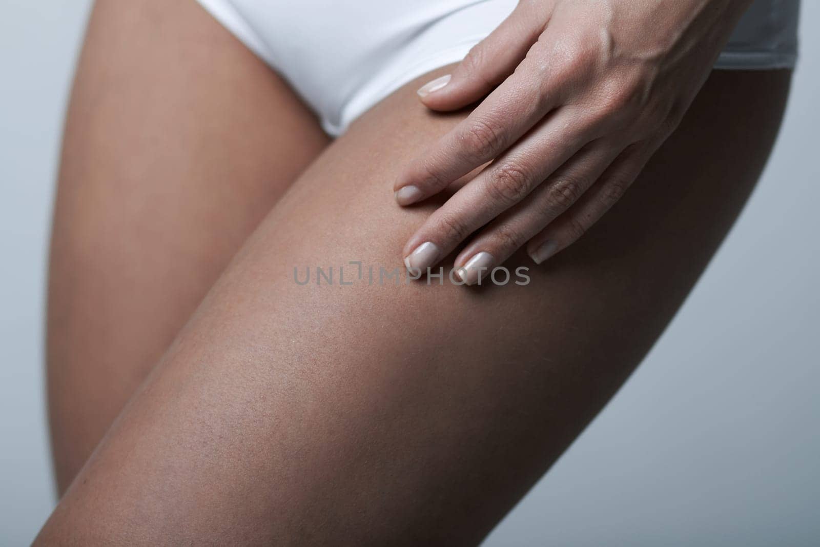 Beautiful womans body part wearing white underwear on clear background