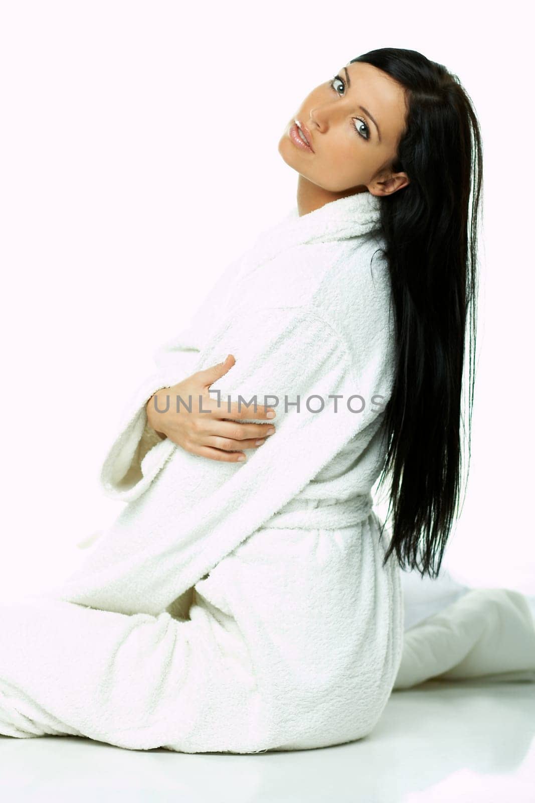 Portrait of Fresh and Beautiful brunette woman on white background wearing white bathrobe