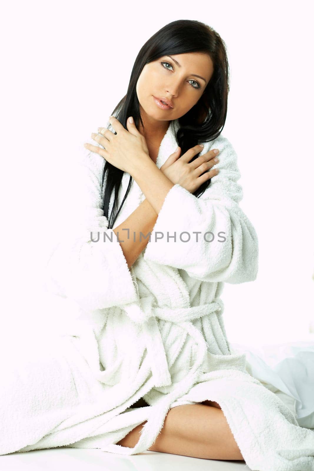 Portrait of Fresh and Beautiful brunette woman on white background wearing white bathrobe