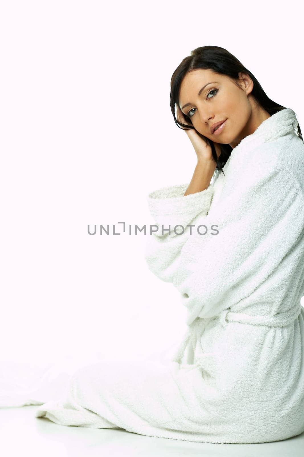 Portrait of Fresh and Beautiful brunette woman on white background wearing white bathrobe