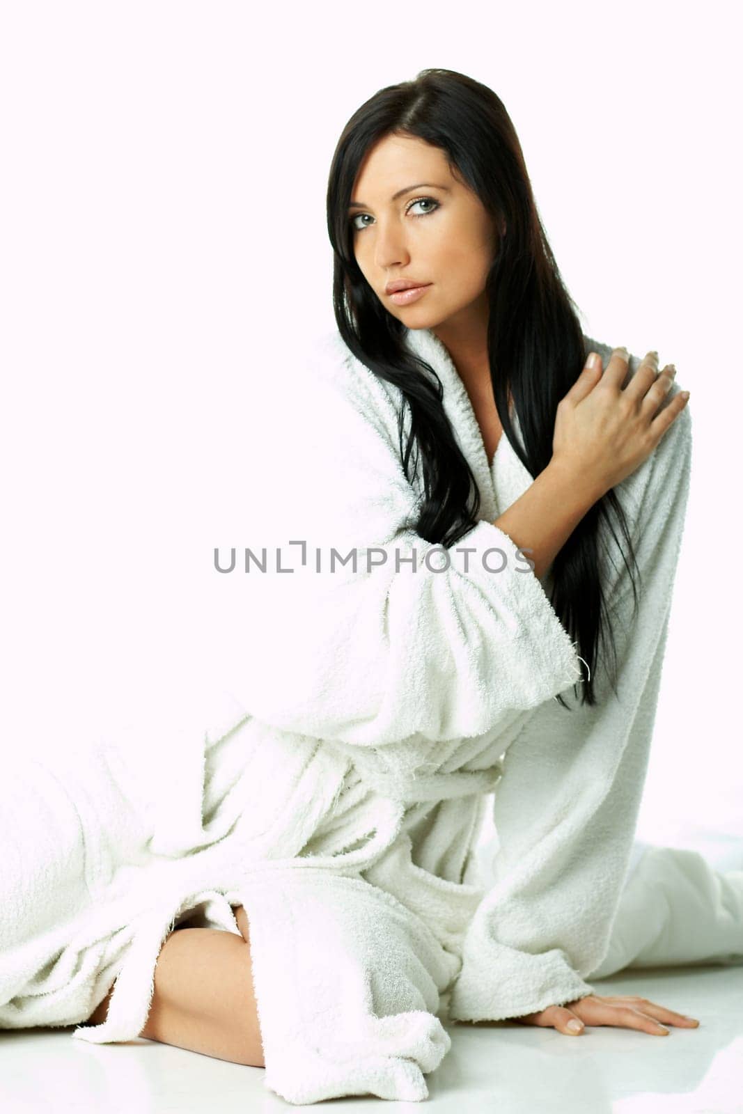 Portrait of Fresh and Beautiful brunette woman on white background wearing white bathrobe