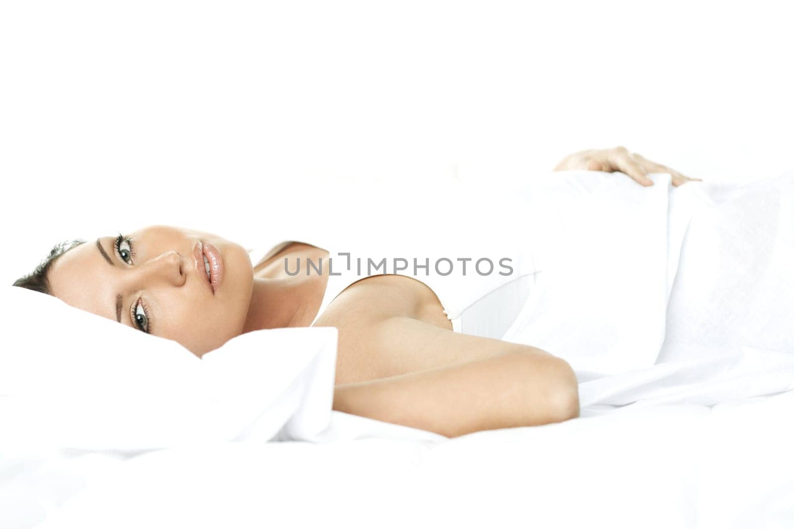 Portrait of Fresh and Beautiful brunette woman on bed